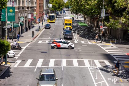 A Cruise self-driving autonomous car drives on Jackson Street in downtown San Francisco