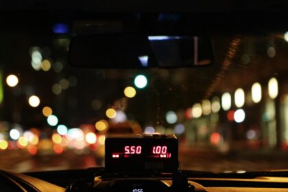 view from inside a taxi cab with fitted meter at night