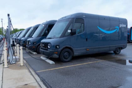 a line of Amazon EV Vans charging